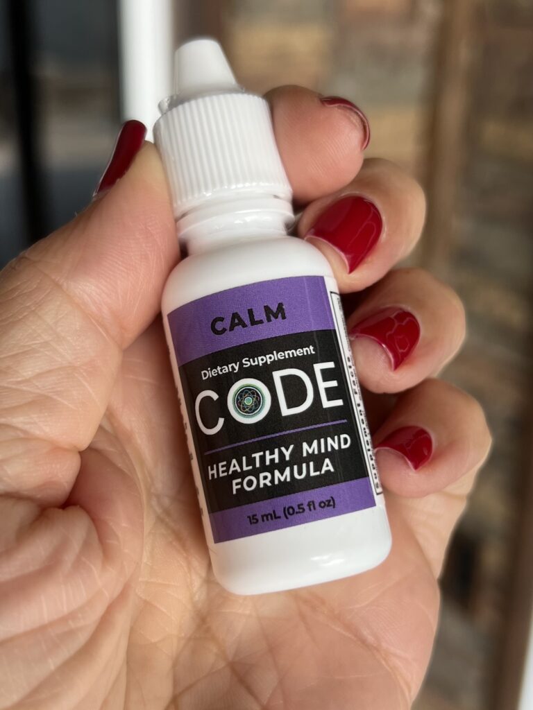 Female Hand holding CODE Health CALM